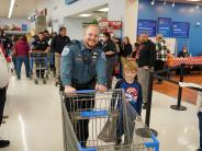 Male Police Officer with child at store