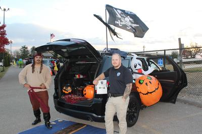 male officers at trunk - or - treat event