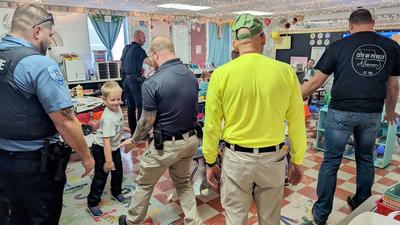 group of male officers and employees with children